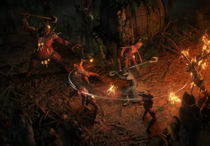 Combattimento intenso in Path of Exile 2 su PS5: un guerriero affronta un gigante rosso e creature infernali tra fiamme e rovine.