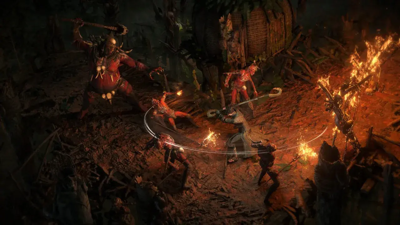 Combattimento intenso in Path of Exile 2 su PS5: un guerriero affronta un gigante rosso e creature infernali tra fiamme e rovine.