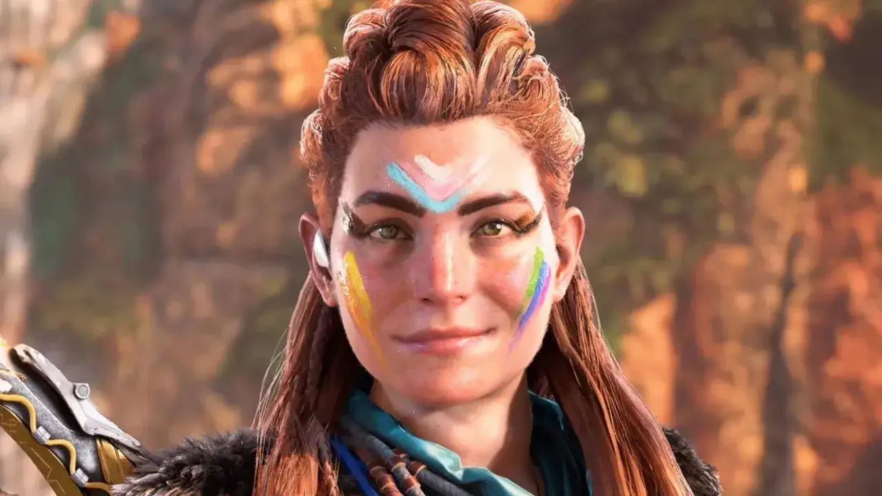 Aloy con vernice arcobaleno sul viso, pronta per nuove avventure in Horizon Forbidden West DLC.