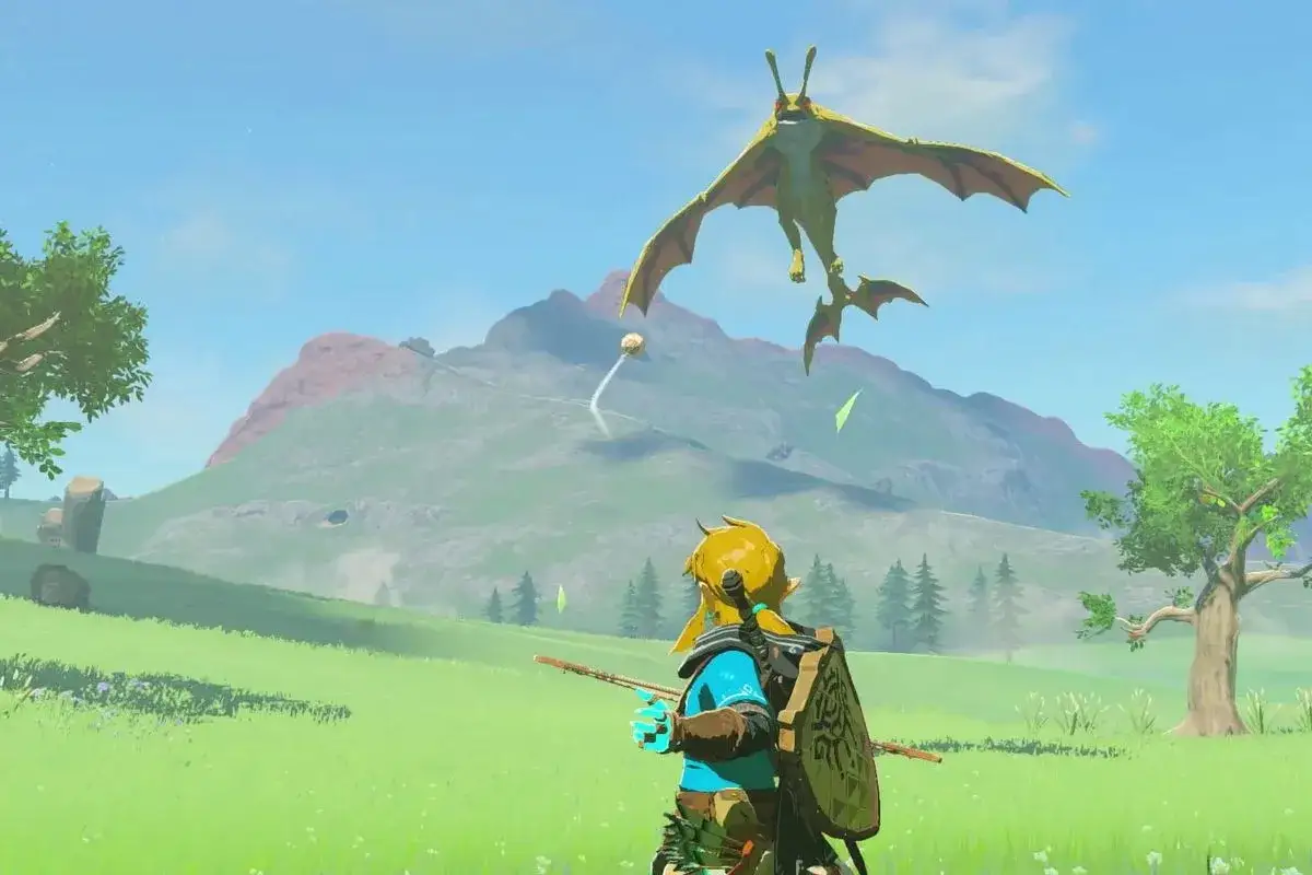 Link affronta un mostro volante in un prato verde, un'immagine iconica per la zelda tears of the kingdom recensione.