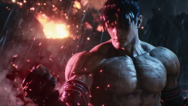 Jin Kazama pronto a combattere in Tekken 8 recensione. Sfondo infuocato e pioggia di scintille.