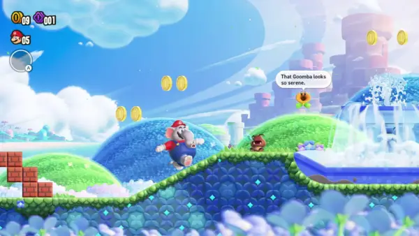 Mario, trasformato in elefante, salta in un mondo colorato di Super Mario Bros. Wonder. Un Goomba osserva una fontana serena.